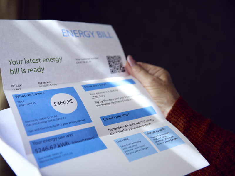 Close Up Of Woman Opening UK Energy Bill Concerned About Cost Of Living Energy Crisis
